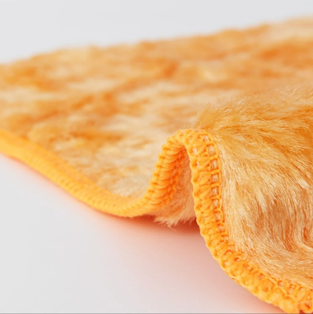 High pile viscose cleaning cloth with rounded hemmed edges for premium product lines.